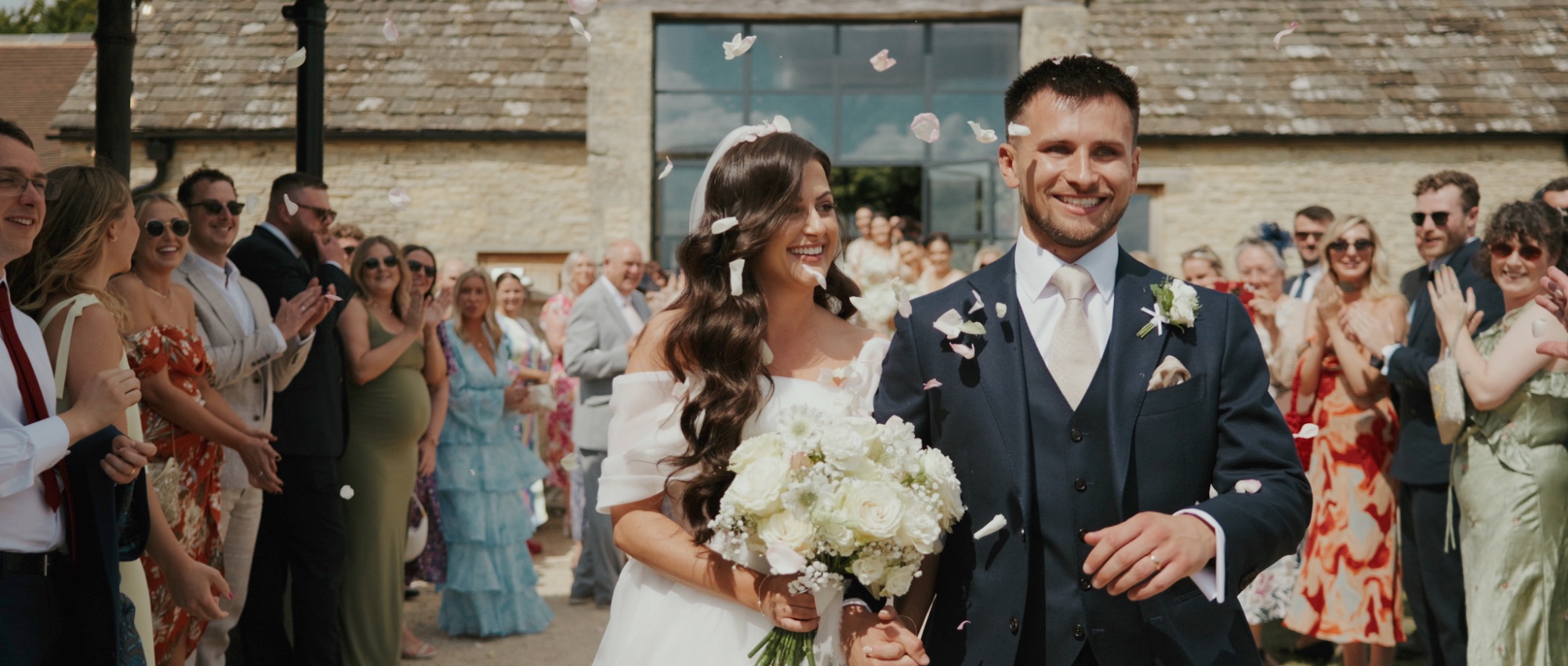 Sarah and Sam confetti exit at Old Gore Barn Cotswolds wedding filmed by Alistair Kings